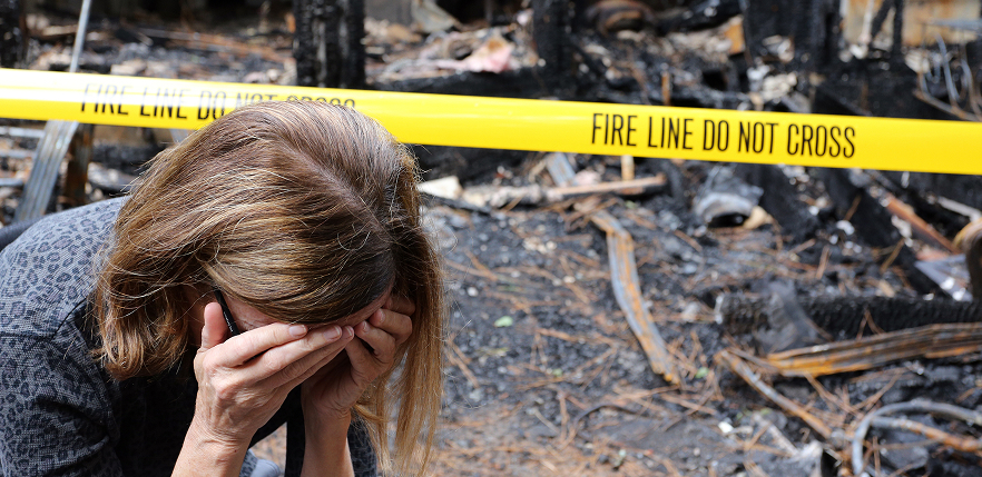 woman upset after fire ruins home